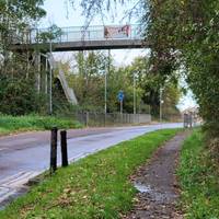 Follow the road around by the school and under the footbridge.