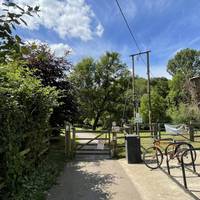 Head straight down towards the river and through the wooden gate. There is bicycle parking on the car park side of the gate.