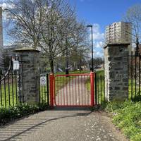 Once you've crossed the greenspace, turn left and walk through the red gate.