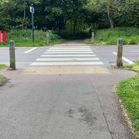 Use the Zebra crossing to cross The Mill Lane and continue along the path.