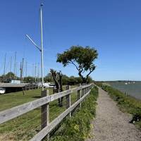 Keep walking forwards past the boat yard.