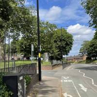 Continue right after crossing the road. Head towards the entrance of Ward End Park.