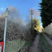 Public footpath on the left, just after the railway bridge.