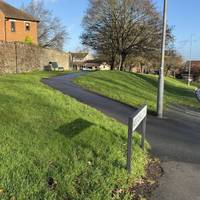 On the left you will see a path across the grass at Priory Green.  Take this path.
