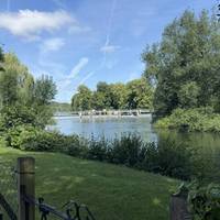 You’ll pass a gated garden area on the river front. Pause to look back to see the Whitlock Weir.