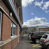 Pick up the tarmac path on the opposite side and head under the covered walkway.