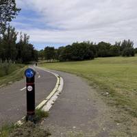 Follow the curved path up the hill.
