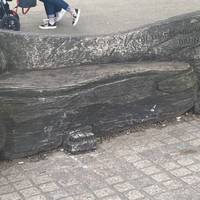 Odd carved seat at the riverside.