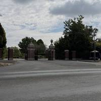 If you look to the left, you’ll see the ornate gates leading to the Landican Cemetery. It was opened in 1934.