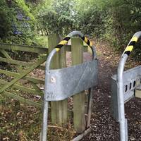 Go through the metal squeeze stile to access the footpath and continue past the purple Trent Valley Greenway sign.