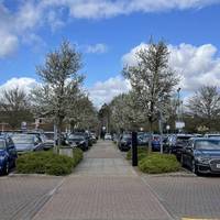 Soon after, turn left and follow the main path through the car park which is lined with young trees. There are dropped kerbs throughout.