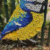 They have been made by residents, local school children and families that collected over 60,000 bottle tops to make