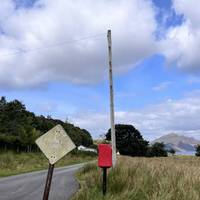 Next to the mailbox you will see a narrow gravel path heading away from it and towards the sea. Walk along it.