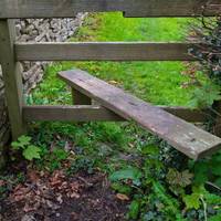 Follow the path and stiles, keeping the wall on the left, until you get to a road. Turn right.