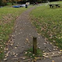 Go onto the path ahead through one of the slightly narrow gaps next to the bollards. The path is level but a little bumpy.