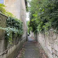 Head up the steep narrow path between the houses.