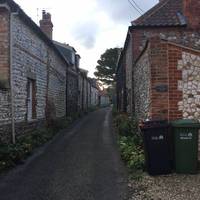 The lane winds between some cottages and eventually turns to a track.