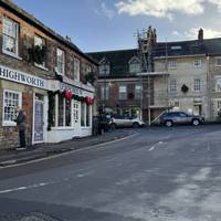 Head across the square and carefully cross the road to be outside the Saracens Head pub
