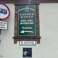 Can you spot a sign for The Sparrows Nest? Underneath ‘Coffee House’ there are 3 words. Note down the third letter of the second word. 📝