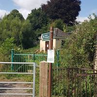 Past the pub, you'll see this footpath sign to your right. Follow it and go through the kissing gate, across a field and up through a wood