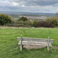Pass wooden bollards and head over the grass towards the bench and the view north.