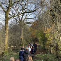 Mind the fallen tree and head towards the bridge with the river flowing from the left.