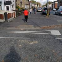 Cross a series of side roads as you proceed along the wide pavement. Unfortunately, some of the kerbs are not well-dropped.