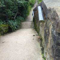 Immediately after the bend and before a pub and supermarket on the left, turn right down steps towards the canal.