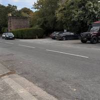 Use the dropped kerb at the driveway to cross over the road to the small carpark at the entrance to the woods.