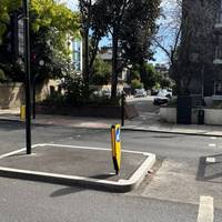 Turn right to cross at the lights and continue through the pedestrian gap into Rochester Square.