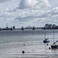 The Thames Barrier shimmering in the distance.