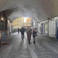 Walk under Tower Bridge and past the old engine rooms. You can see the chimney next to the bridge which is part of the tour experience.