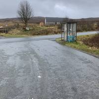 Stay on the road until you come to another bus stop then carefully cross over on to the path that bears right up the hill.