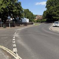 Head back to the high street and cross over Manor Rd and around this walled off village green.