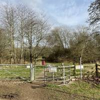 At the end of the street, pass the car park and go through the metal gate.
