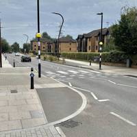 Cross at the pedestrian crossing and then continue in the same direction.