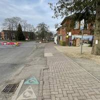Turn left on the opposite side, heading towards the small roundabout.