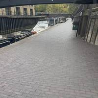 Head across the bridge and then down to the canal side. Turn to go under the bridge and away from the basin.