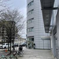 Continue on this road toward the big round hotel ahead.