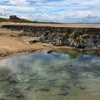 Once through the dunes you arrive at the beach near these rocks, it's often quiet, always wonderful. Turn left and head towards the castle.