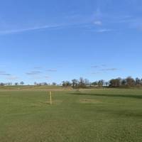 Begin a slight ascent up the hill and across the park land. The public footpath runs parallel with the road to the left.