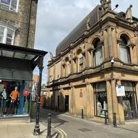 Cross Station Square and walk along Market Place.