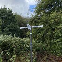 The fingerpost has many destinations! You're going left, towards the Leeds & Liverpool canal.