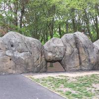 These are some boulders to climb on! There is a small basketball area and exercise machines to the right of these. 