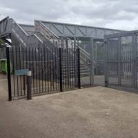 You will come to this gate and stairs over the station platforms. Continue straight ahead past the stairs.