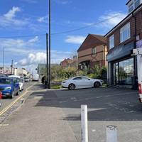 Turn left on the opposite side past a few business and a housing block.