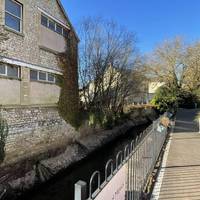 Shortly after, turn right to walk alongside Wellow Brook in front of some houses. The river should be on your left.