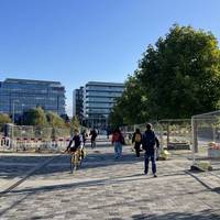 Turn right onto a shared path towards a wide metal bridge known locally as the Cheese Grater Bridge.
