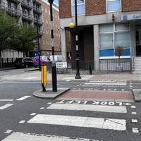 Either cross over the zebra crossing or take the right onto Maple Street.