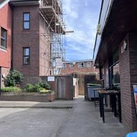 With the car park and toilets on your left, turn right to walk down the alleyway beside the station. The entrance is quite narrow.